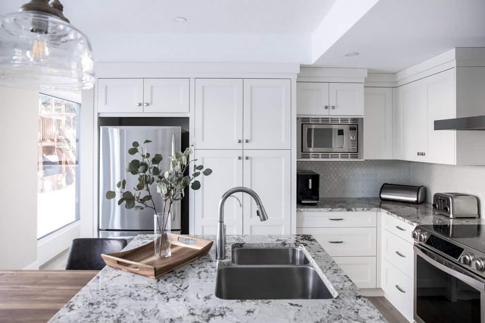 Family friendly white kitchen with wood Caribou countertop island (Calgary)